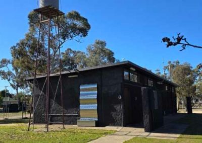 Amenities building with water tower at Stawell Grampians Gate C&C Park – one of the features available across Cabins, Dwellings, Caravans, & Glamping Tents.