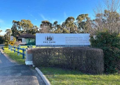 Entrance sign at Stawell Grampians Gate C&C Park, displaying park name, website, and a list of available accommodation types including Cabins, Dwellings, Caravans, & Glamping Tents.