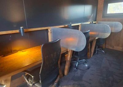 Private coworking space with individual desk booths and black modern chairs at lakeside space in Stawell Grampians Gate C&C Park.