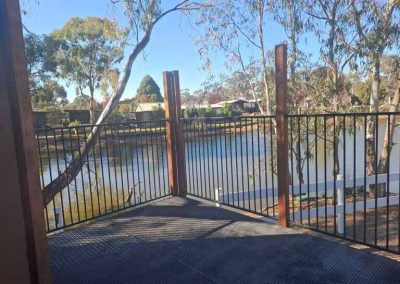 Peaceful lake view from elevated deck surrounded by trees at Stawell Grampians Gate C&C Park.