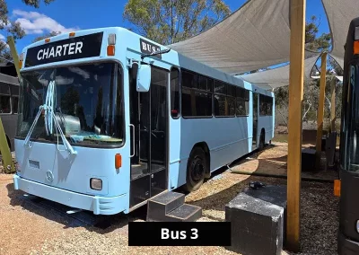 Black-painted charter bus converted into accommodation at Stawell C&C Park near the Grampians.