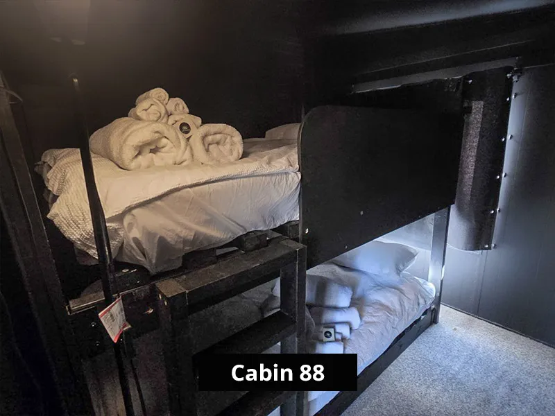 Cabin 88’s second bedroom with two sets of bunk beds and soft lighting, ideal for families or group stays.